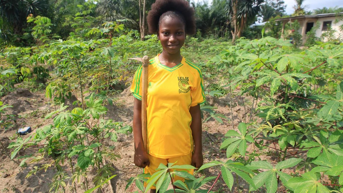 Young girl standing in a a farm field